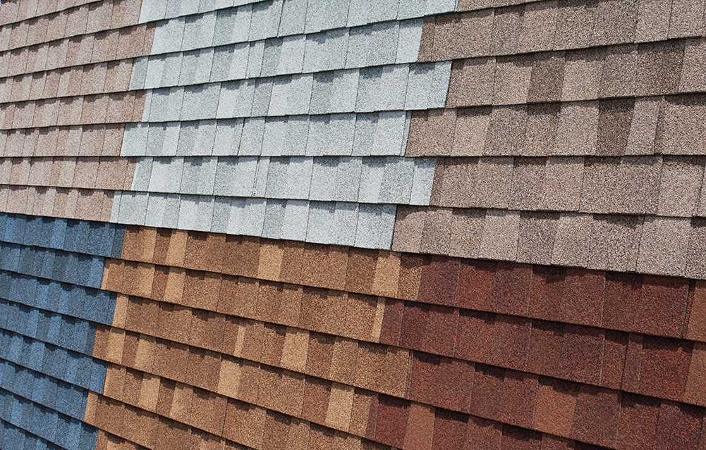 An image of an asphalt shingle display showing shingle for roof replacement services in six different colors.