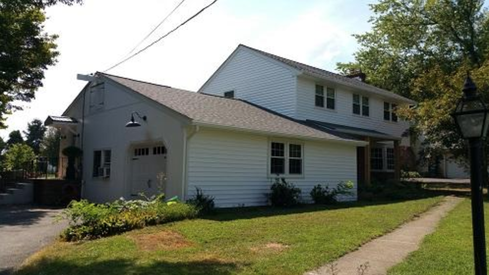 White two-story PA home after vinyl siding installation