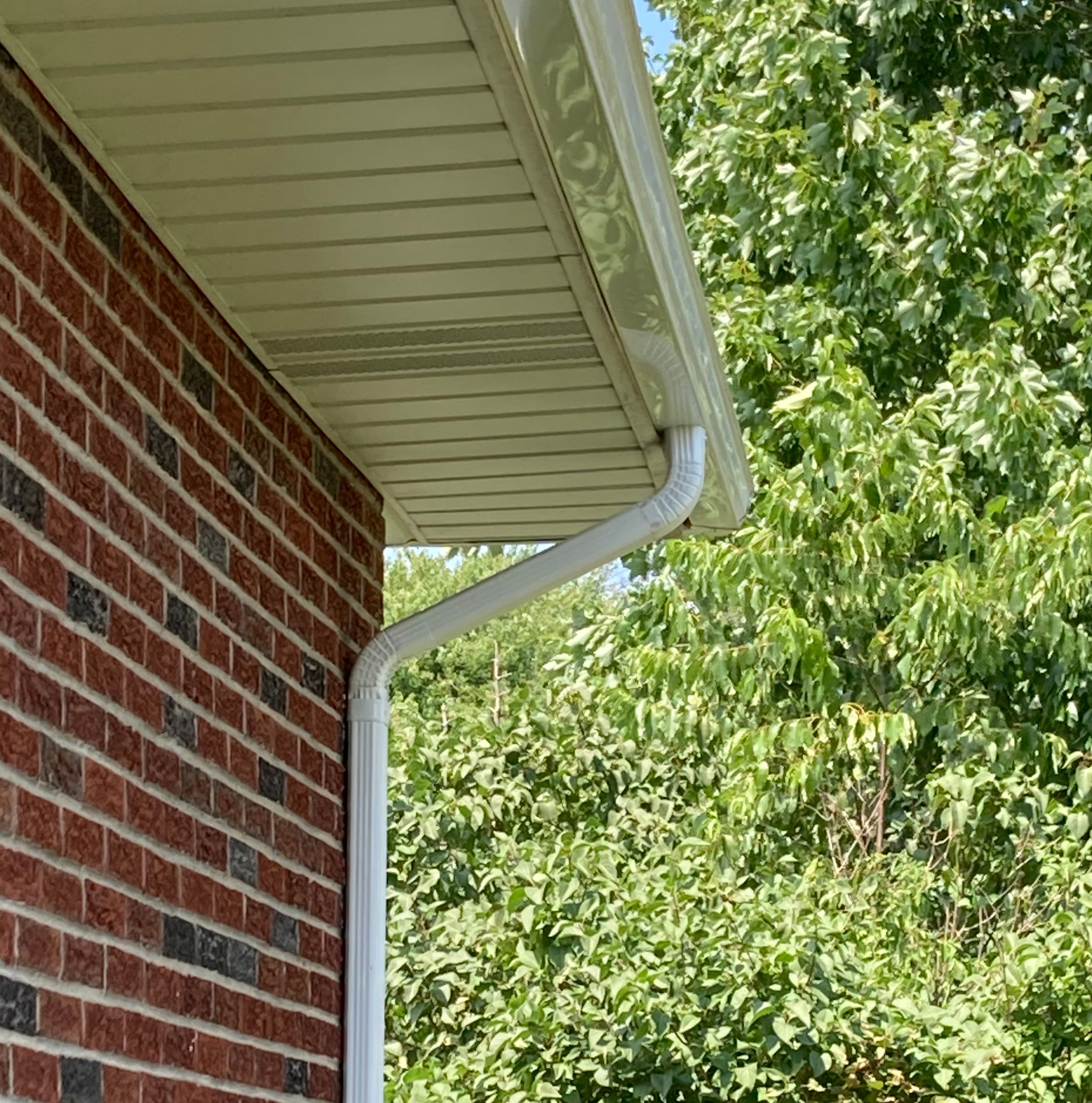 Brick exterior home with new gutters and downspouts.