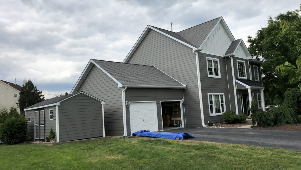 grey suburban home after working with siding contractors in Montgomery County to