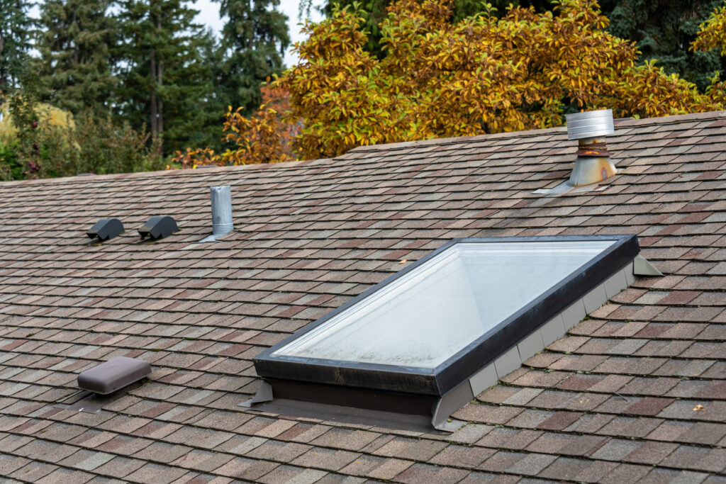 Rooftop view of residential home in bucks county pa with asphalt shingle roof with skylight and roof vents