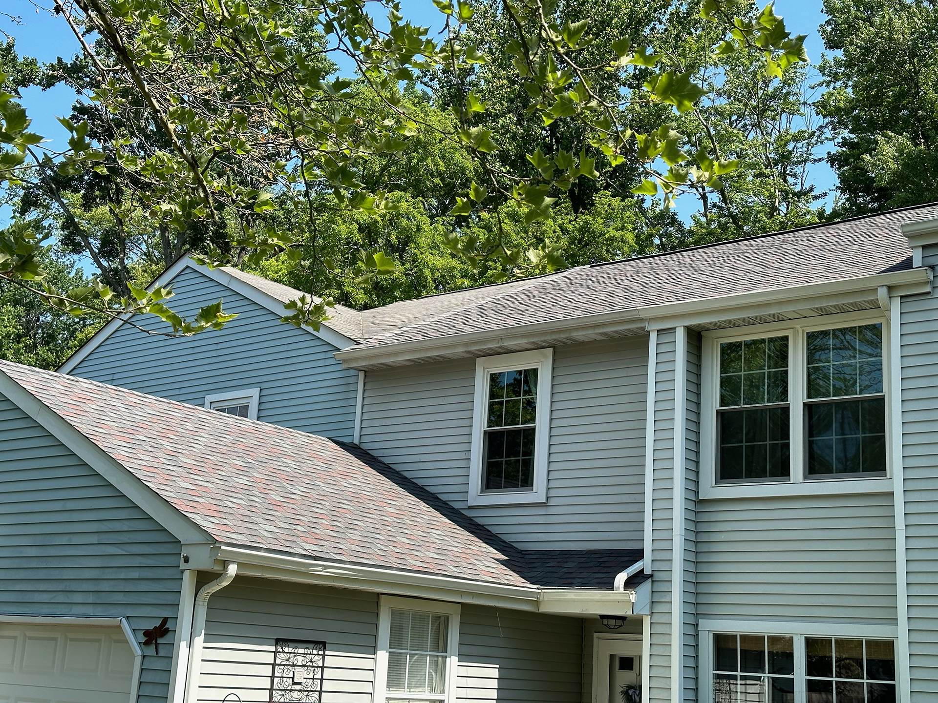 Blue home in Doylestown, PA after roof replacement in Bucks County, PA.