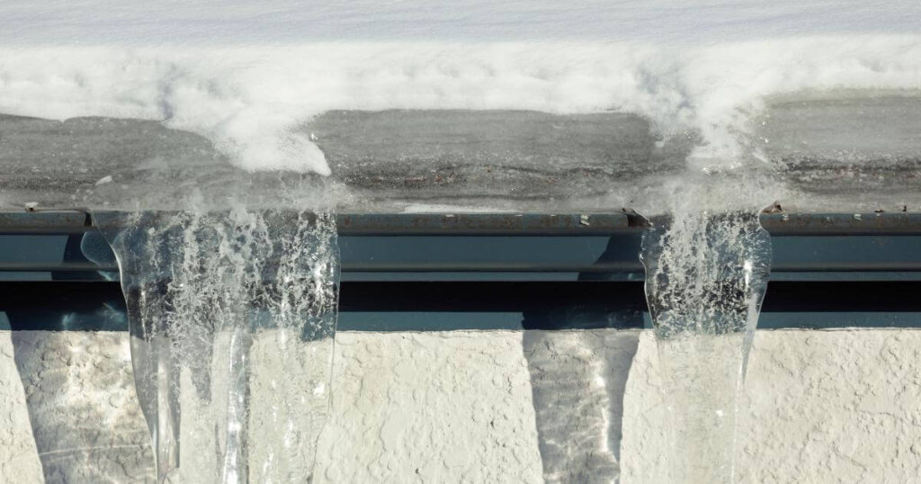 Ice dam formed on snowy roof top, a common roofing problem in PA